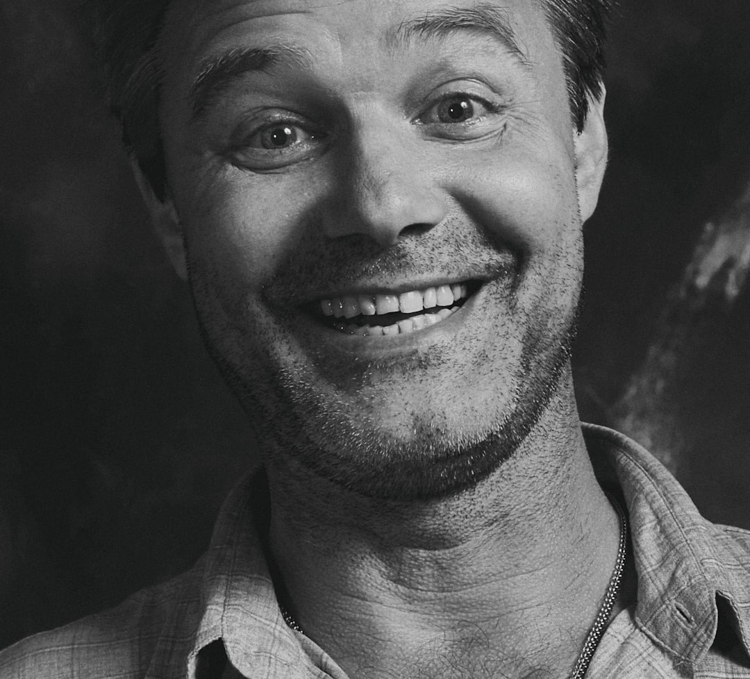 Studio portrait of a brazilian man with short hair smiling