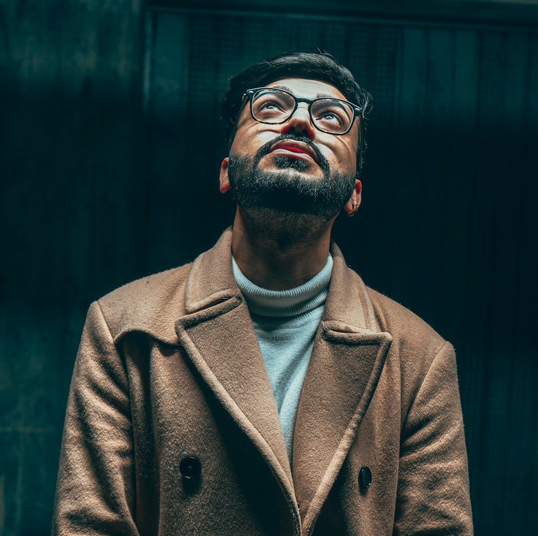 Studio portrait of a brazilian man with a beard and glasses